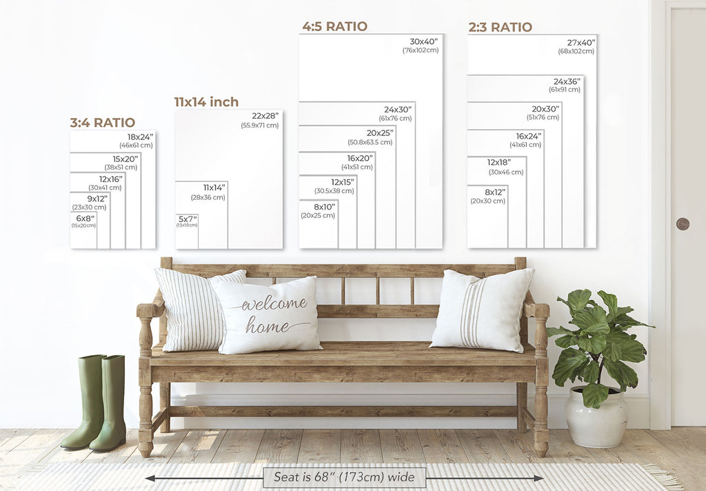 a wooden bench with pillows, a potted plant, and a pair of boots, all set against a white wall. Above the bench, there are three framed size charts providing measurements for different print sizes, including "3/4" and "2/3" ratio sizes.
